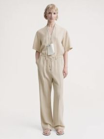 TOTEME_PF23_TROUSERS_233-2023-214_PRESS-CREASED_DRAWSTRING_TROUSERS_OVERCAST_BEIGE_012_540x.jpg.jpeg